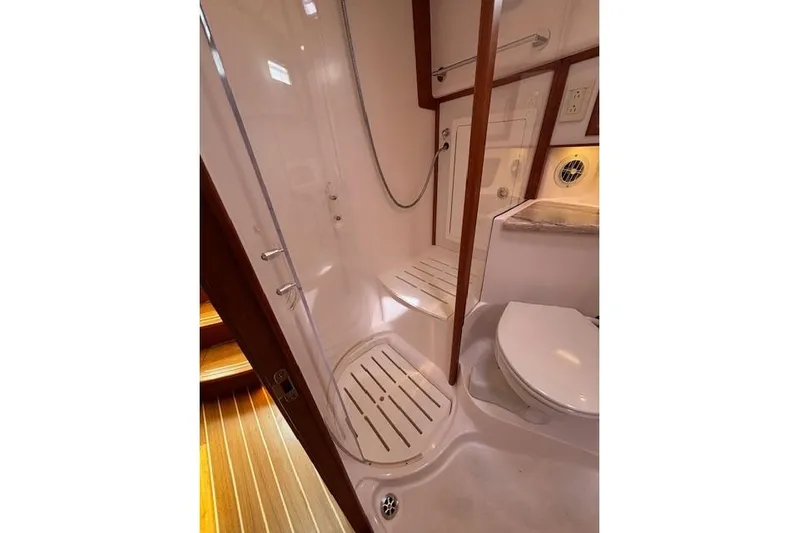  Yacht Photos Pics Bathroom interior of 2015 Sabre 42 Salon Express yacht, featuring shower and toilet.