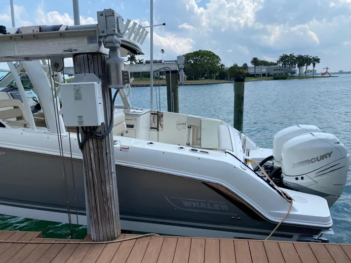 Fins Up Yacht Photos Pics 2017 Boston Whaler 320 Vantage docked by the water with Mercury outboard engine.