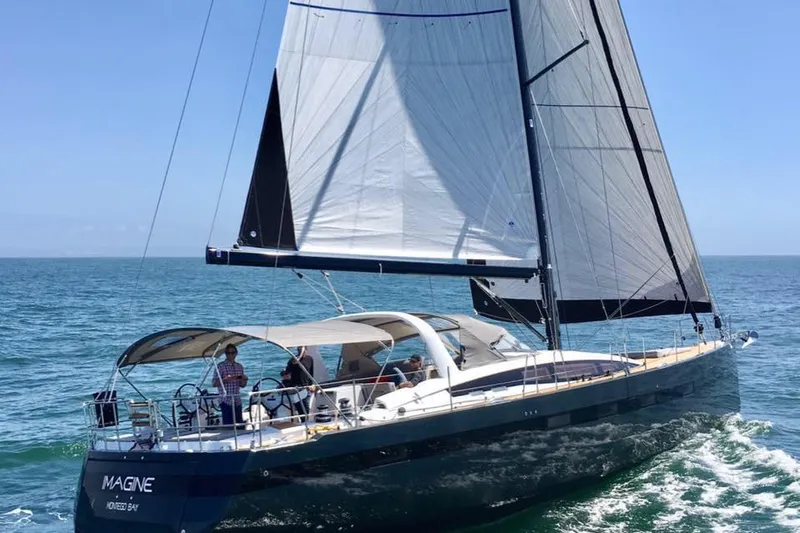Imagine Yacht Photos Pics 2017 Jeanneau 64 sailing yacht cruising on open sea under clear blue skies.