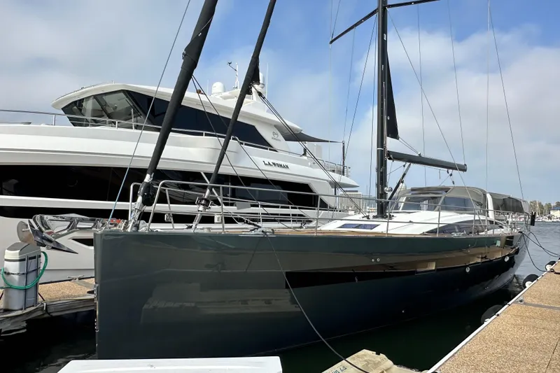 Imagine Yacht Photos Pics 2017 Jeanneau 64 yacht docked at marina, sleek design, black hull, and modern features.