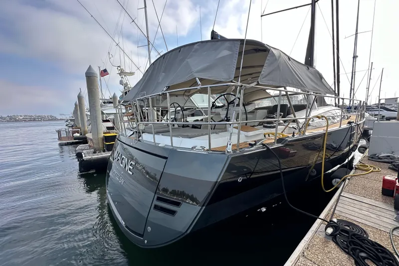 Imagine Yacht Photos Pics 2017 Jeanneau 64 yacht docked at marina, featuring sleek design and covered deck.