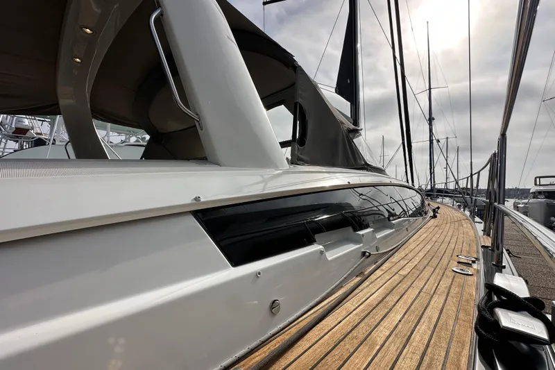 Imagine Yacht Photos Pics 2017 Jeanneau 64 yacht with sleek design and wooden deck, docked at marina.