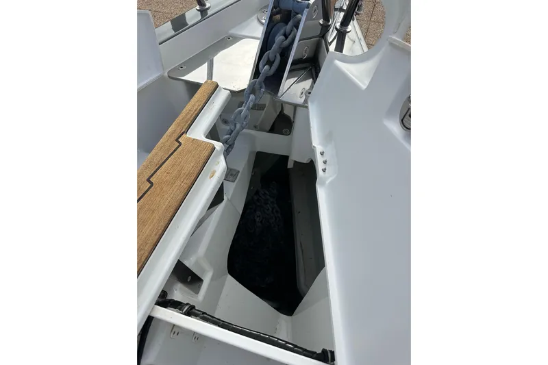Imagine Yacht Photos Pics Anchor chain compartment on a 2017 Jeanneau 64 sailboat, featuring teak accents.