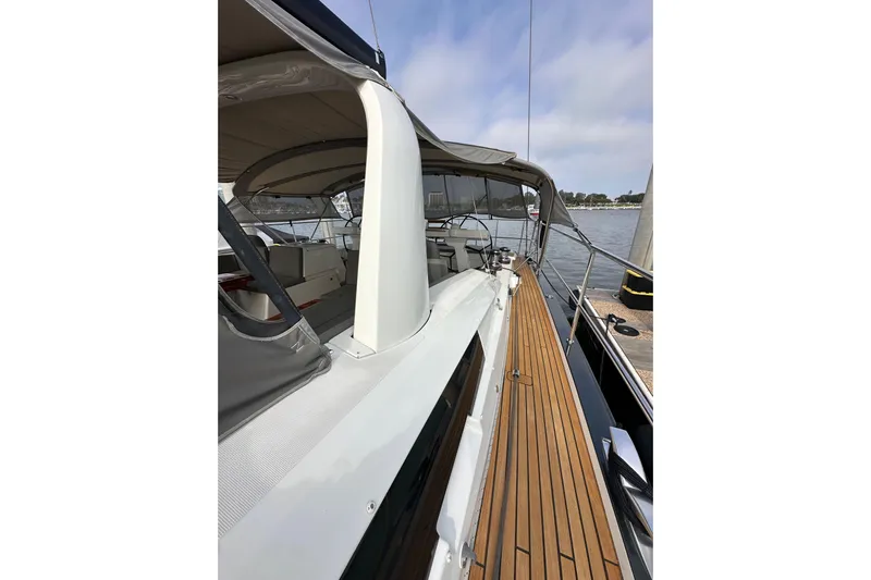 Imagine Yacht Photos Pics 2017 Jeanneau 64 yacht with teak deck, docked by the water.