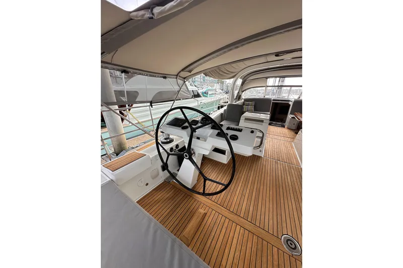 Imagine Yacht Photos Pics Luxurious 2017 Jeanneau 64 yacht cockpit with wooden flooring and modern steering wheel.