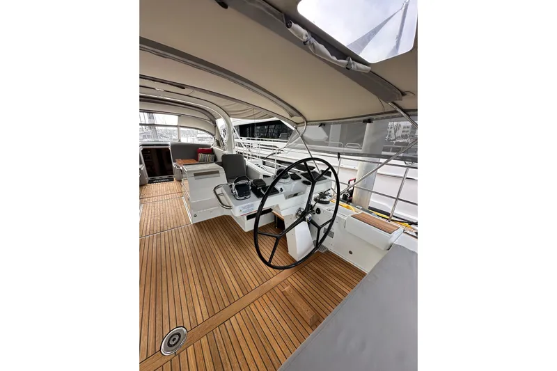 Imagine Yacht Photos Pics Cockpit of 2017 Jeanneau 64 yacht with teak flooring and dual steering wheels.