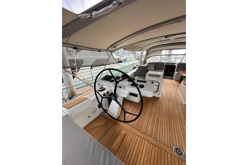 Imagine Yacht Photos Pics 2017 Jeanneau 64 yacht cockpit with wooden deck and steering wheel.