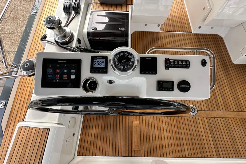 Imagine Yacht Photos Pics Helm station of 2017 Jeanneau 64 yacht with modern navigation instruments and teak decking.