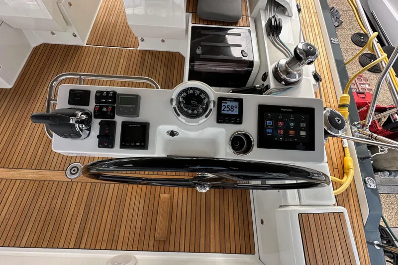 Imagine Yacht Photos Pics Cockpit of 2017 Jeanneau 64 yacht with navigation controls and teak flooring.