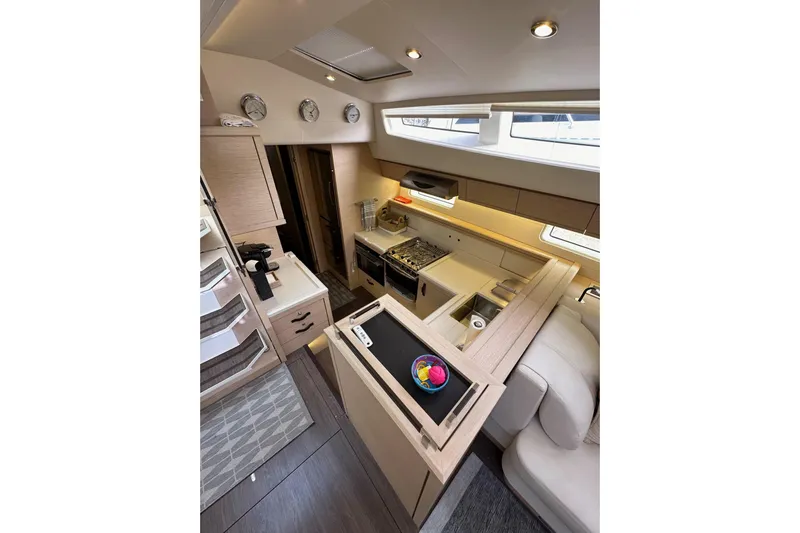 Imagine Yacht Photos Pics Luxurious interior of 2017 Jeanneau 64 yacht featuring modern kitchen and elegant design.