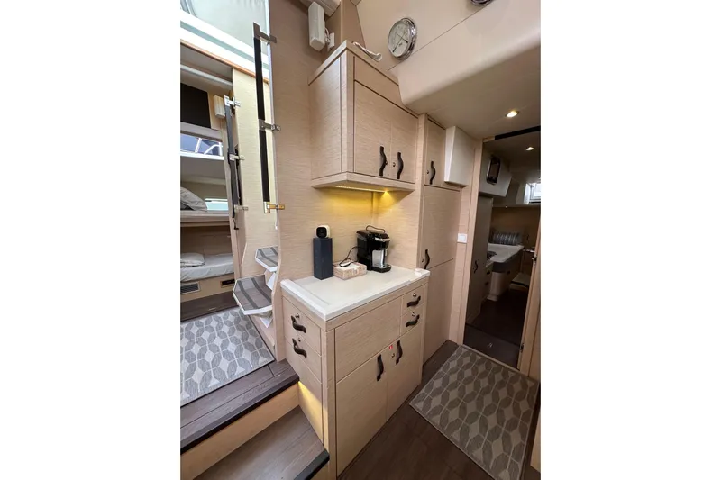 Imagine Yacht Photos Pics Interior of 2017 Jeanneau 64 yacht with modern cabinetry and cozy living space.