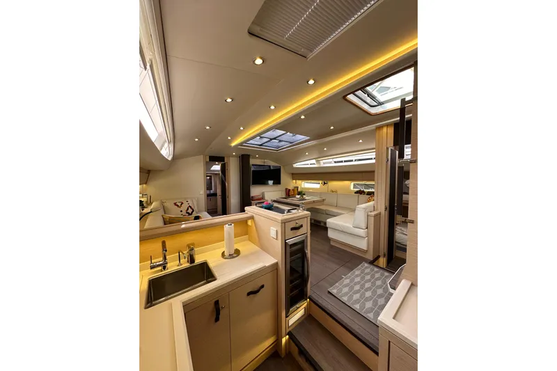 Imagine Yacht Photos Pics Luxurious interior of 2017 Jeanneau 64 yacht, featuring modern kitchen and spacious seating area.