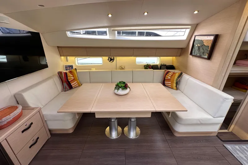 Imagine Yacht Photos Pics Luxurious interior of 2017 Jeanneau 64 yacht with elegant dining area and modern decor.
