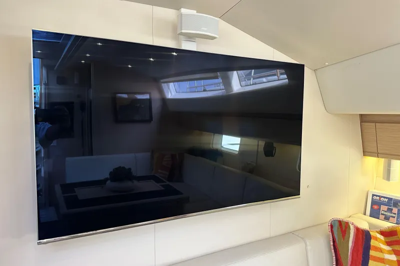 Imagine Yacht Photos Pics Interior of 2017 Jeanneau 64 yacht featuring a mounted flat-screen TV.