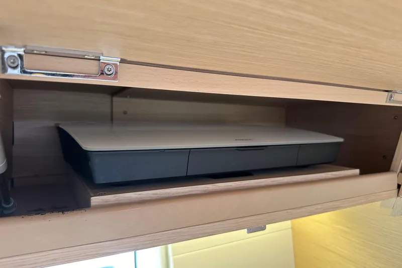 Imagine Yacht Photos Pics Wooden cabinet with a printer inside on a 2017 Jeanneau 64 yacht.