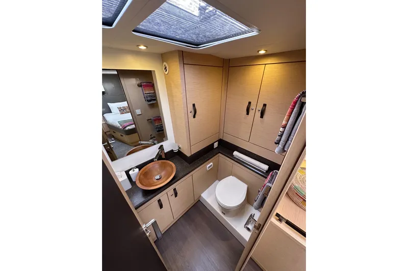 Imagine Yacht Photos Pics Luxurious bathroom interior of 2017 Jeanneau 64 yacht with modern fixtures and wooden cabinetry.