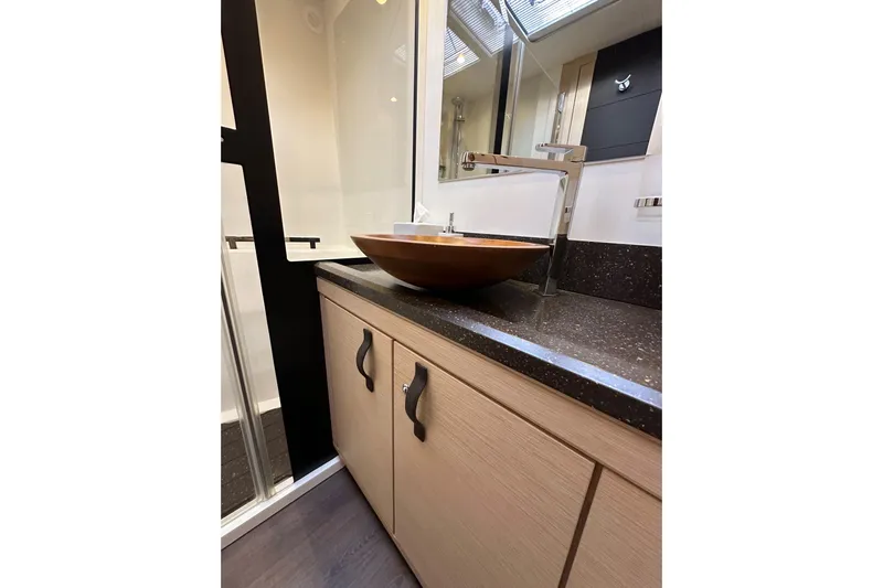 Imagine Yacht Photos Pics Luxurious bathroom sink area on a 2017 Jeanneau 64 yacht, featuring modern design elements.