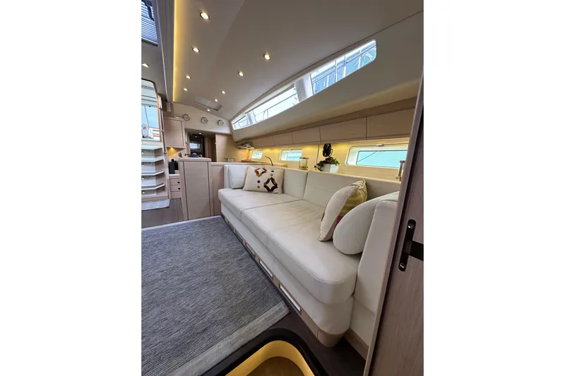 Imagine Yacht Photos Pics Luxurious interior of 2017 Jeanneau 64 yacht with elegant seating and modern lighting.
