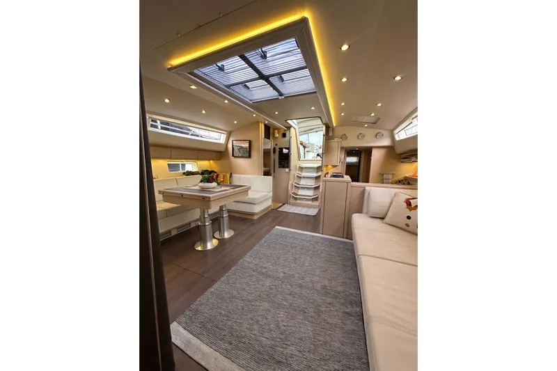 Imagine Yacht Photos Pics Luxurious interior of a 2017 Jeanneau 64 yacht with elegant seating and modern lighting.