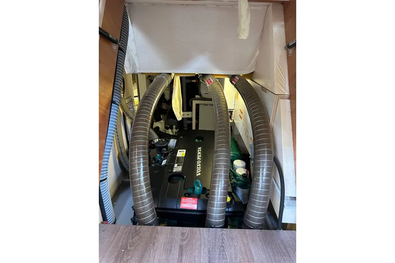 Imagine Yacht Photos Pics Engine room of 2017 Jeanneau 64 yacht with Volvo Penta engine and ventilation hoses.