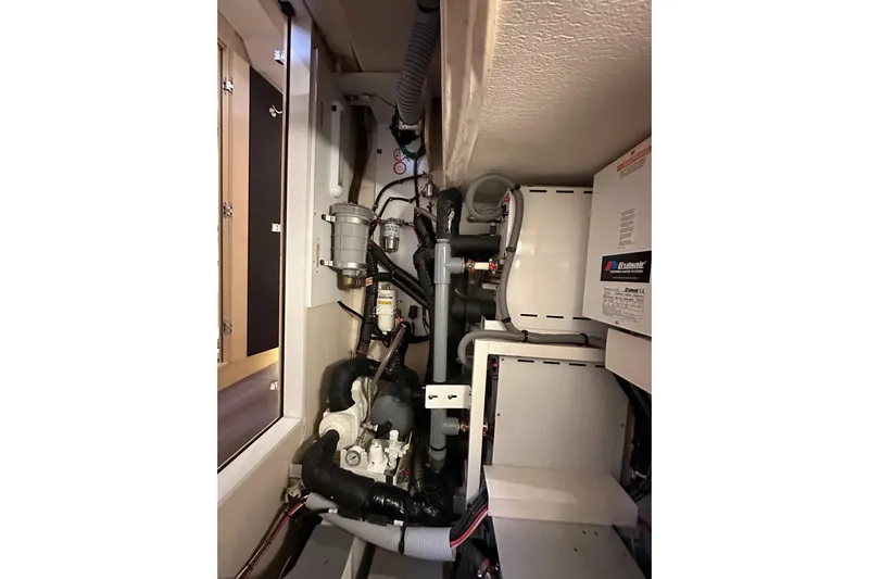 Imagine Yacht Photos Pics Engine room of a 2017 Jeanneau 64 yacht, showcasing mechanical components and systems.