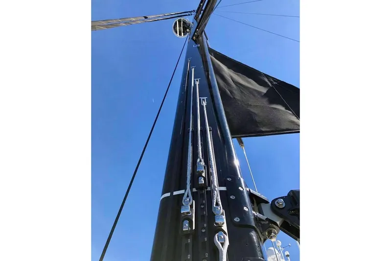 Imagine Yacht Photos Pics Mast and rigging of 2017 Jeanneau 64 sailboat against clear blue sky.