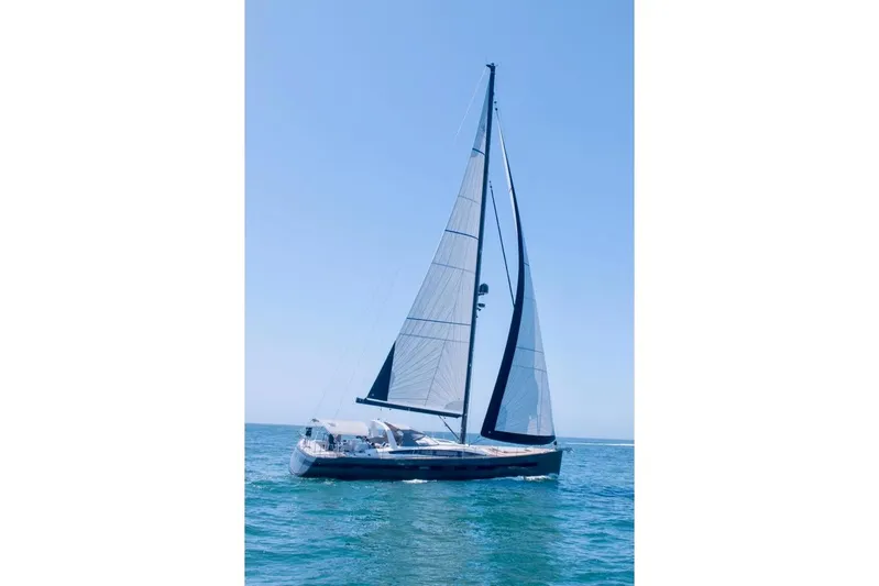 Imagine Yacht Photos Pics 2017 Jeanneau 64 sailboat cruising on open water under clear blue skies.
