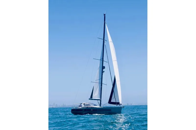 Imagine Yacht Photos Pics 2017 Jeanneau 64 sailing on open sea under clear blue sky.