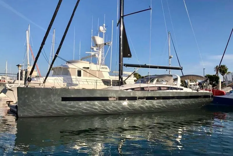 Imagine Yacht Photos Pics 2017 Jeanneau 64 yacht docked in a marina under clear blue skies.