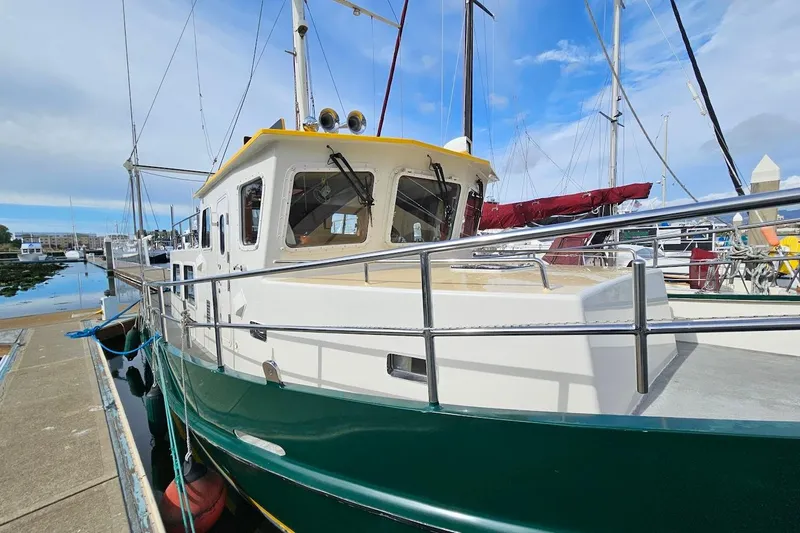 Carquinas Coot Yacht Photos Pics 2010 Seahorse COOT boat docked at marina, featuring green hull and white cabin.