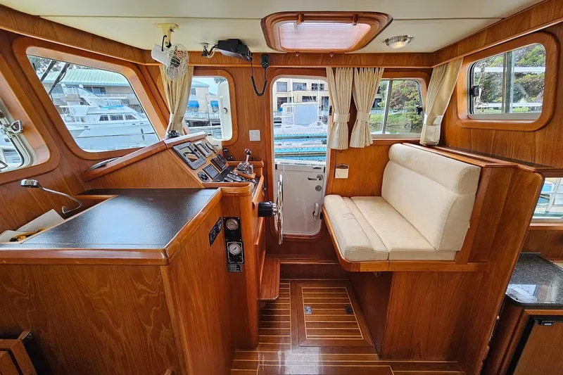 Carquinas Coot Yacht Photos Pics Interior of 2010 Seahorse COOT boat with wooden finish and cushioned seating.