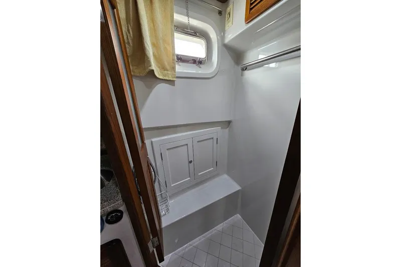 Carquinas Coot Yacht Photos Pics Compact bathroom interior of 2010 Seahorse COOT boat with window and storage cabinets.