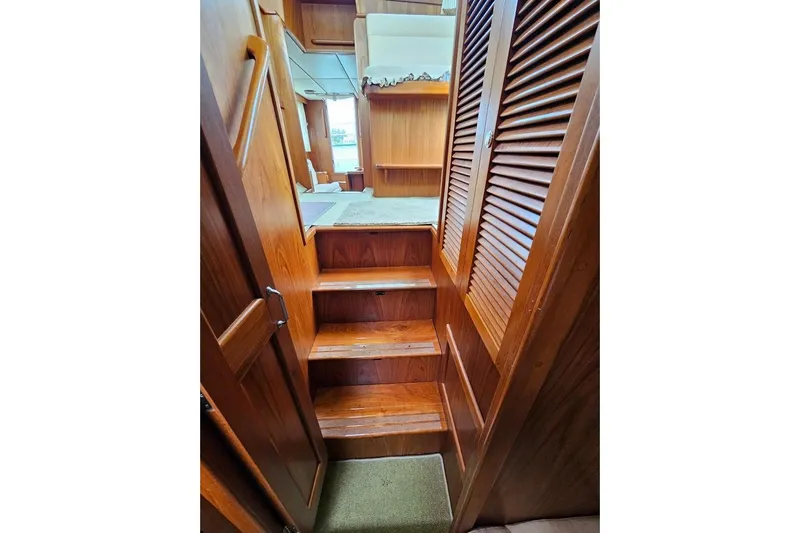 Carquinas Coot Yacht Photos Pics Wooden interior stairs inside 2010 Seahorse COOT boat, featuring warm tones and carpeted steps.