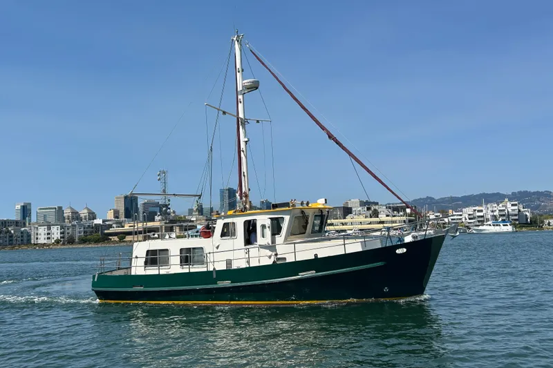 Carquinas Coot Yacht Photos Pics Seahorse COOT 2010 boat sailing near city skyline on a sunny day.