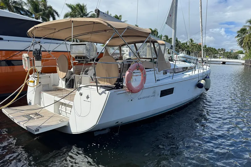 Reventador Yacht Photos Pics 2018 Jeanneau Sun Odyssey 440 sailboat docked, featuring a spacious deck and canopy.