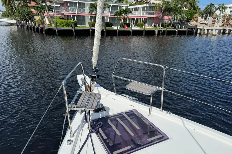 Reventador Yacht Photos Pics Jeanneau Sun Odyssey 440 sailboat deck, docked near waterfront homes, 2018 model.