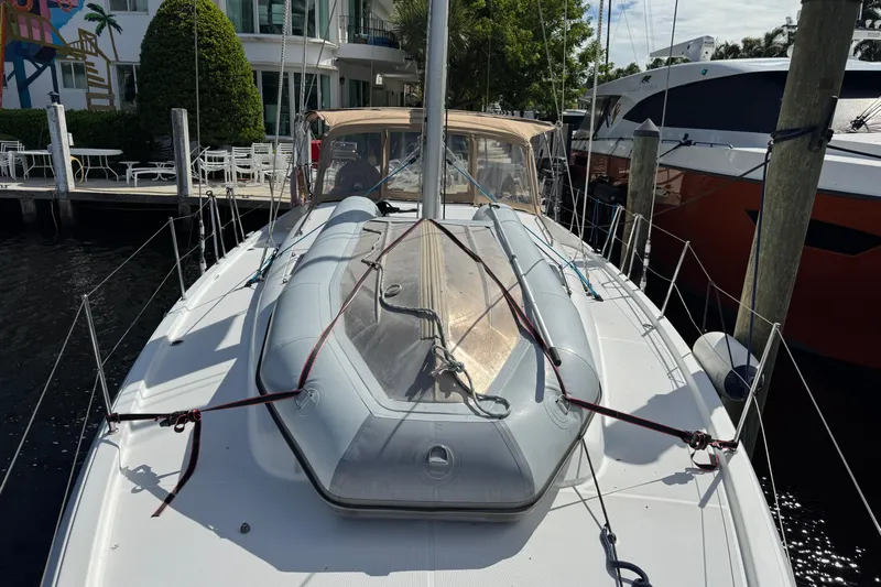 Reventador Yacht Photos Pics 2018 Jeanneau Sun Odyssey 440 yacht docked, featuring inflatable dinghy on deck.
