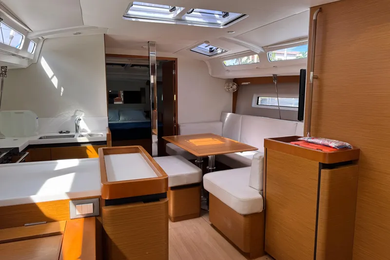 Reventador Yacht Photos Pics Interior of 2018 Jeanneau Sun Odyssey 440 yacht with modern kitchen and dining area.
