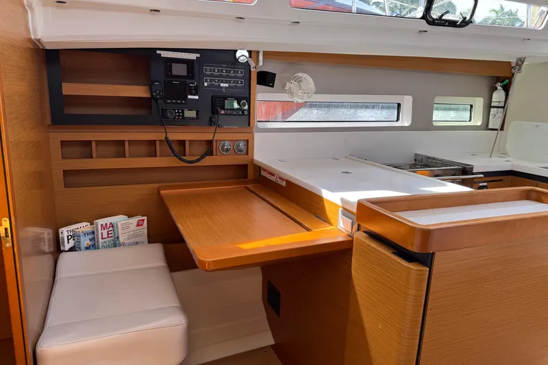 Reventador Yacht Photos Pics Interior of 2018 Jeanneau Sun Odyssey 440 yacht with navigation station and seating area.