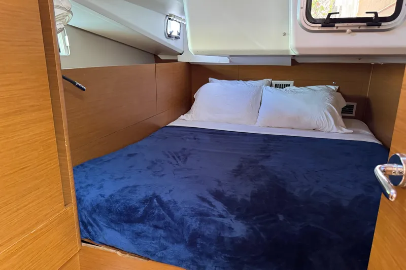 Reventador Yacht Photos Pics Cozy cabin interior of 2018 Jeanneau Sun Odyssey 440 with plush bedding.