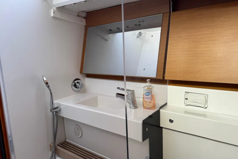 Reventador Yacht Photos Pics Modern bathroom in 2018 Jeanneau Sun Odyssey 440 yacht with sink and mirror.