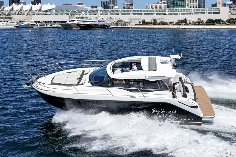 Bag Secured Yacht Photos Pics 2023 Bavaria SR36 yacht cruising in a vibrant harbor setting.