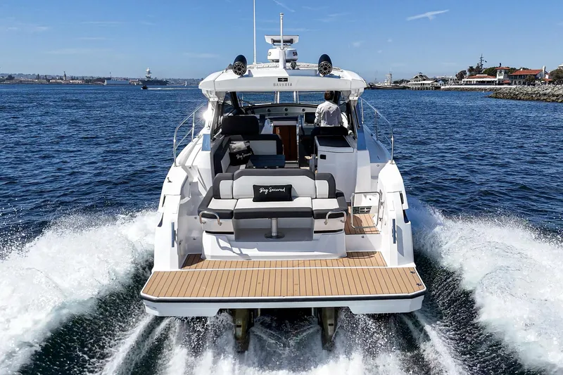 Bag Secured Yacht Photos Pics 2023 Bavaria SR36 yacht cruising on open water, rear view.