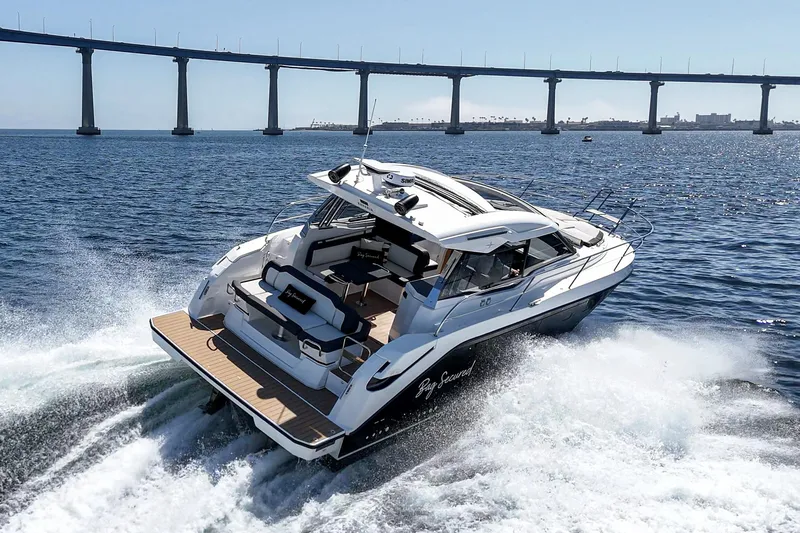 Bag Secured Yacht Photos Pics 2023 Bavaria SR36 yacht cruising under a bridge on open water.
