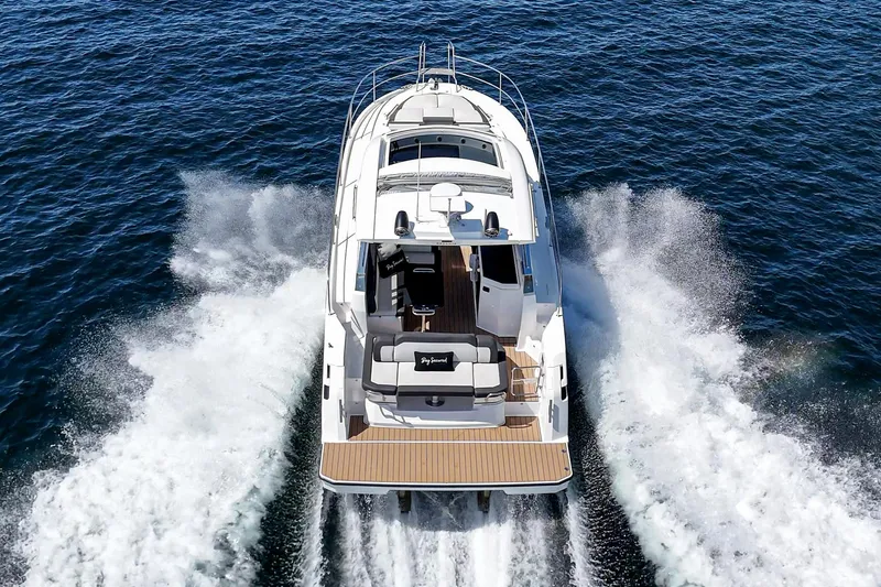 Bag Secured Yacht Photos Pics 2023 Bavaria SR36 yacht cruising on open water, rear view.