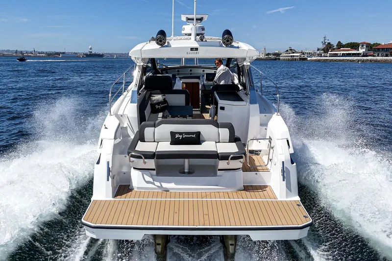 Bag Secured Yacht Photos Pics 2023 Bavaria SR36 yacht cruising on open water, rear view.