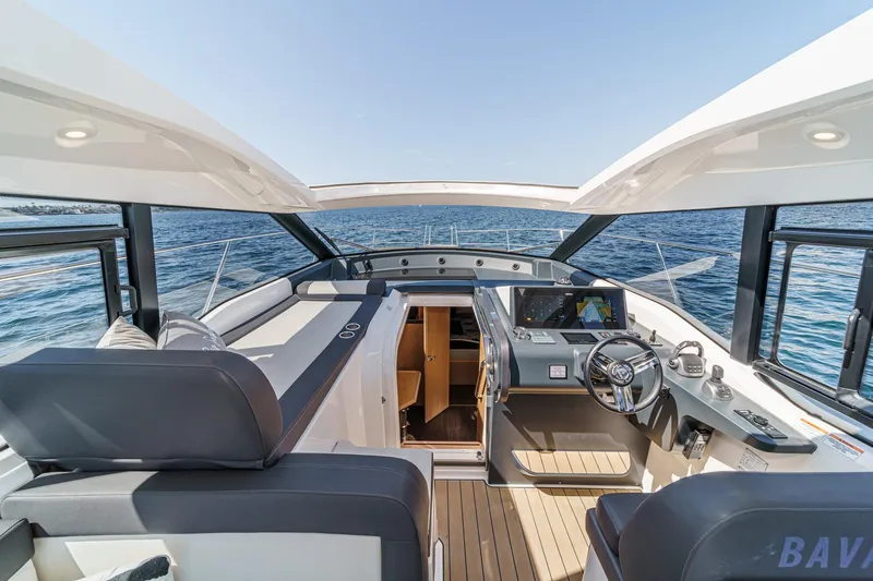 Bag Secured Yacht Photos Pics 2023 Bavaria SR36 yacht interior with modern helm, open sea view.