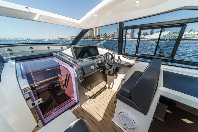 Bag Secured Yacht Photos Pics Interior of 2023 Bavaria SR36 yacht with modern helm and city skyline view.
