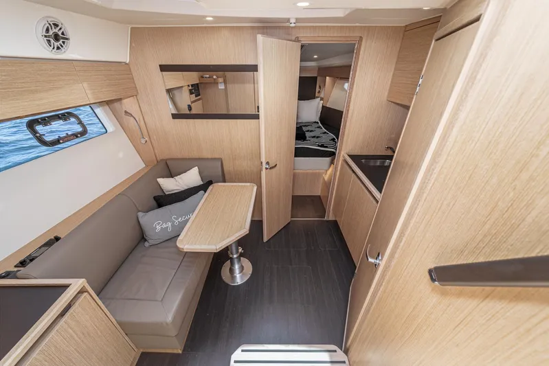 Bag Secured Yacht Photos Pics Interior of 2023 Bavaria SR36 yacht, featuring modern wood finish and cozy seating area.