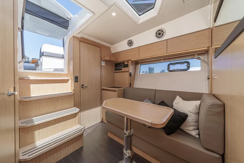 Bag Secured Yacht Photos Pics Interior of 2023 Bavaria SR36 yacht with modern seating and wooden accents.